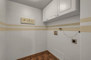 Laundry room with cabinets.