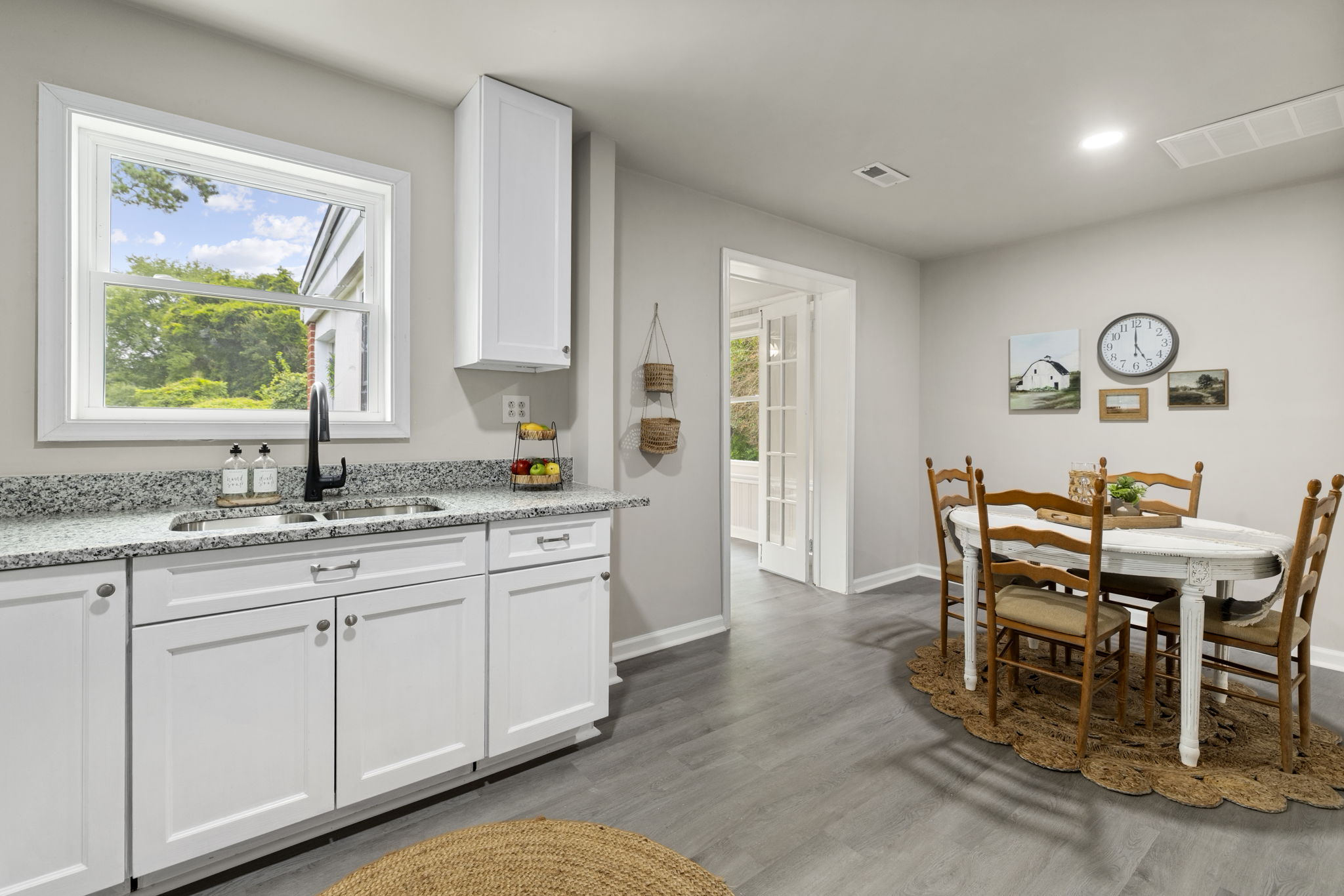 Bright kitchen with plenty of natural light opens to the dining room.