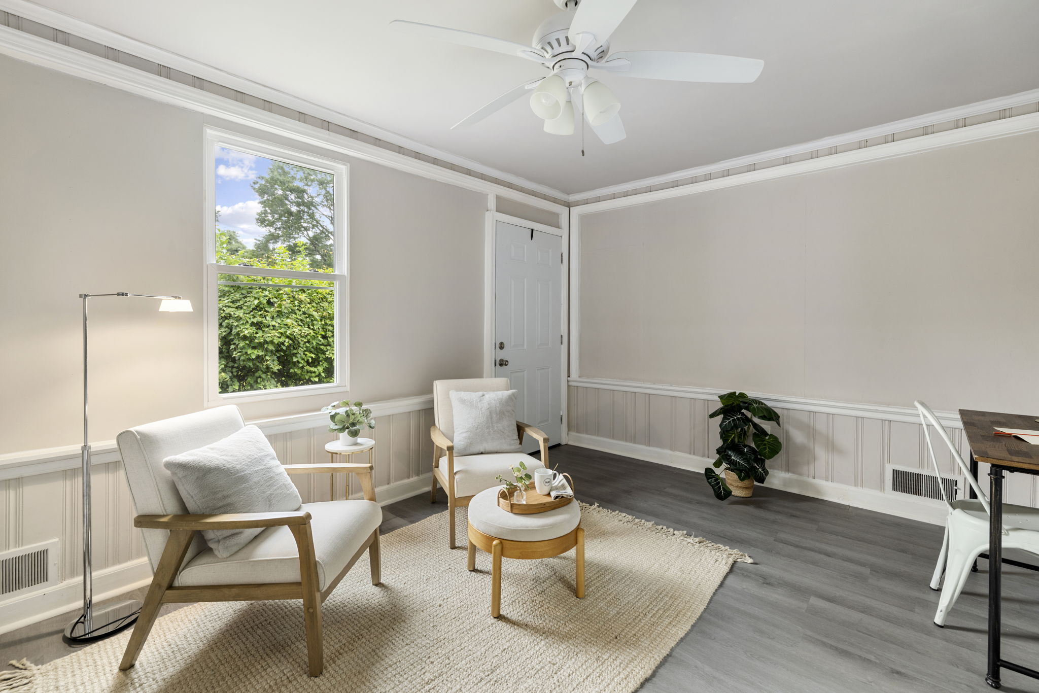 Rear family room with ceiling fan, new Anderson, windows, new exterior door, & LVP flooring.