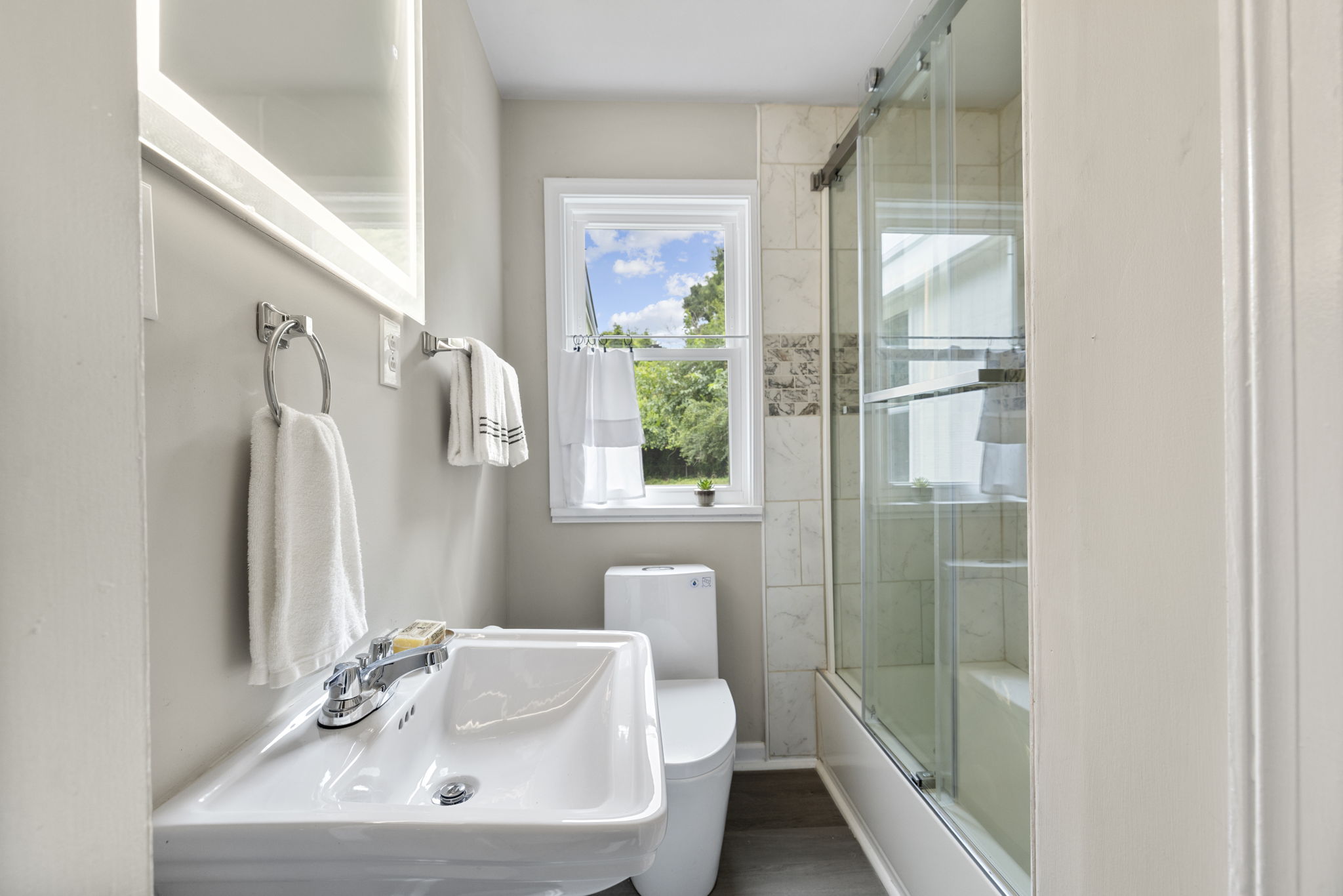 1st floor full hall bath with new LED back light mirror & finishes.