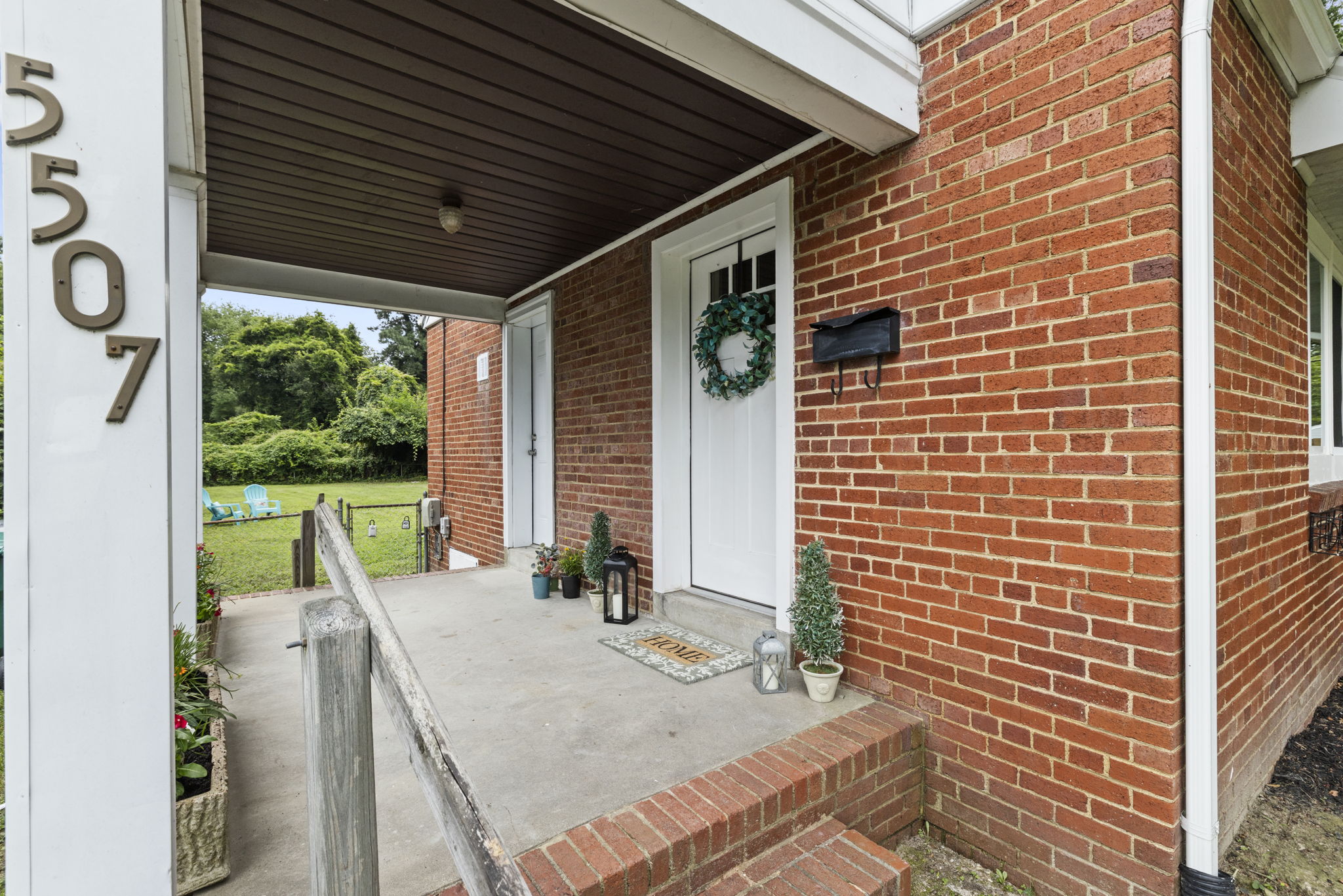 Enjoy the side covered porch with entries to the living room & kitchen.