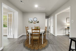 Dining room with recessed can lighting & new LVP flooring.