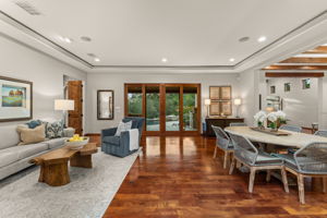 Indulge in a lifestyle of luxury and leisure from the dining room and the first of three living spaces, all framed by views of the pool and canyon lands.