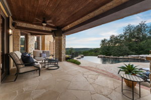 The large covered back patio is adorned with a retractable awning that provides even more shaded space to enjoy.