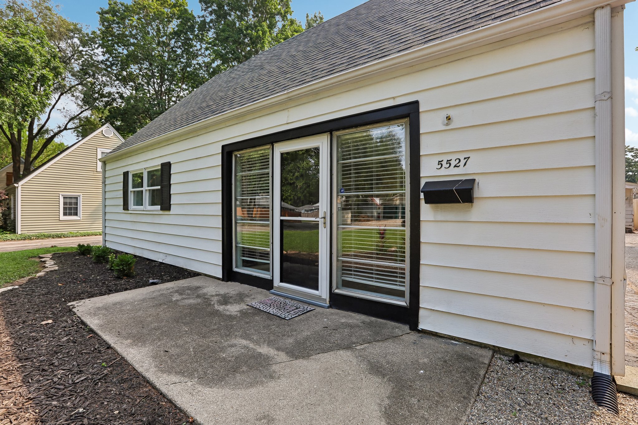 A distinctive front entrance, framed by two full-length glass windows, fills the home with natural light and makes a memorable welcome.