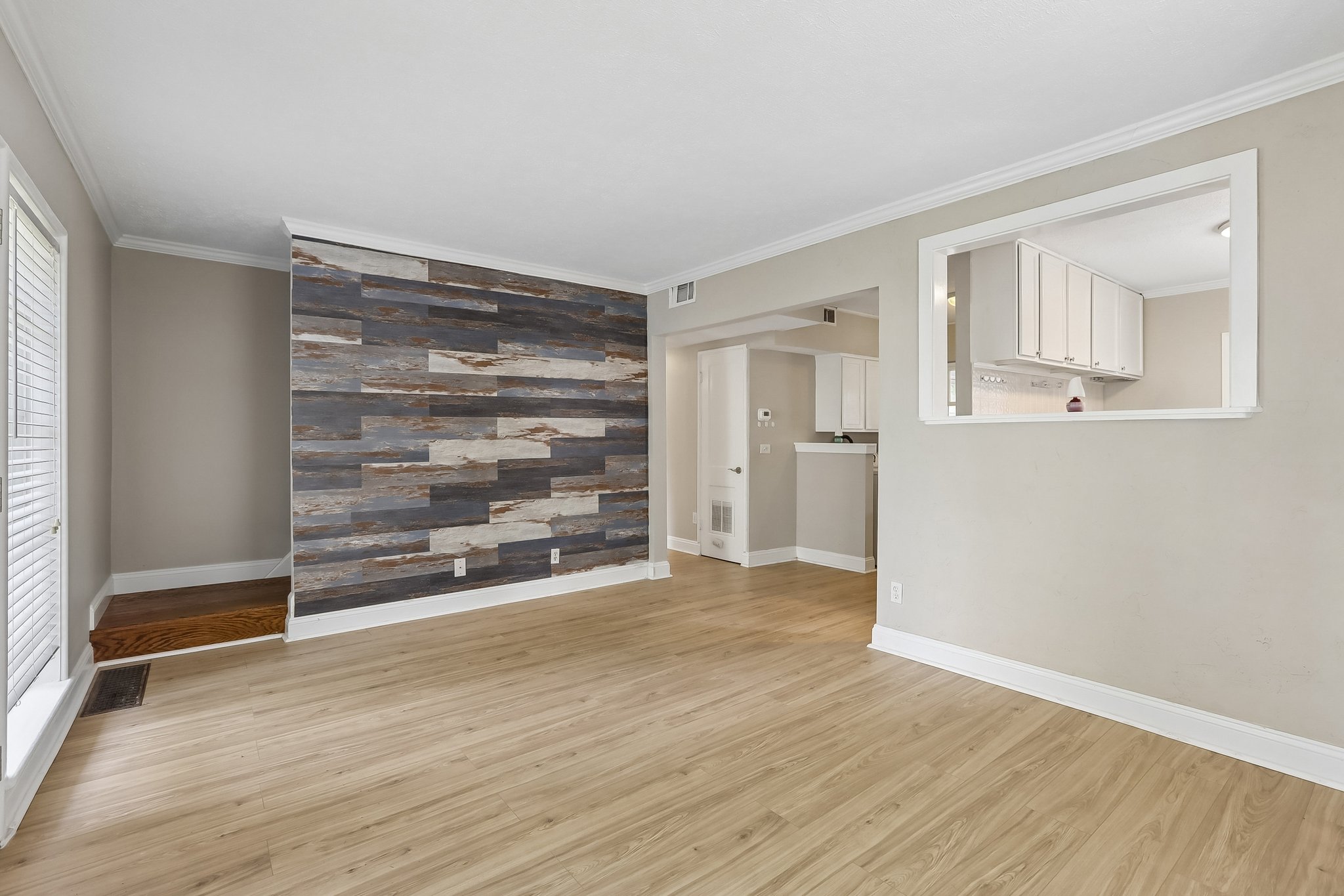 The open layout keeps the living room connected to the kitchen and dining area, making everyday life and entertaining feel effortless.