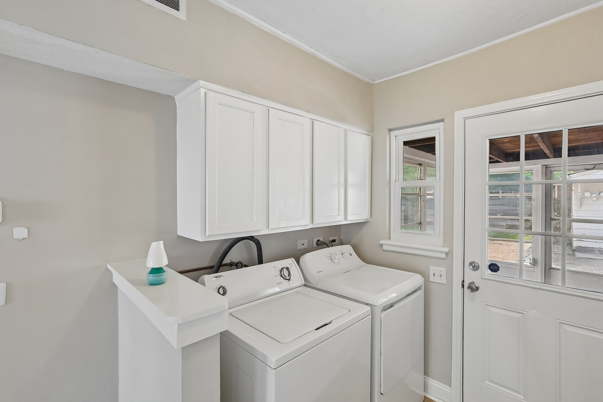 A dedicated laundry with storage, a utility sink, and exterior access helps keep daily routines organized.
