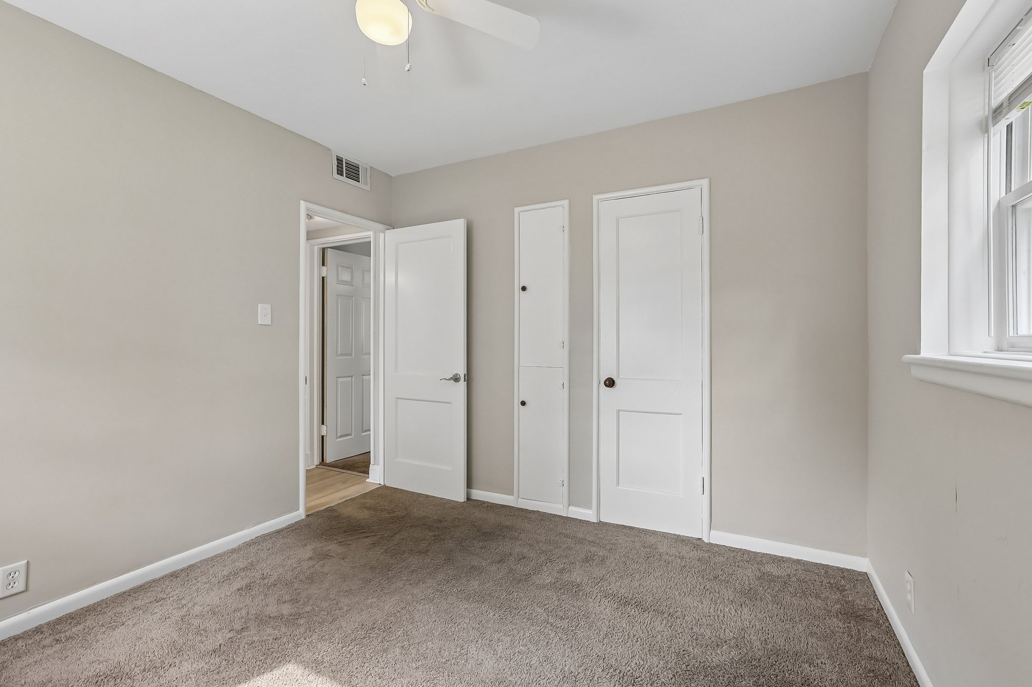 This comfortable main-level bedroom offers abundant natural light and two closets for excellent storage.