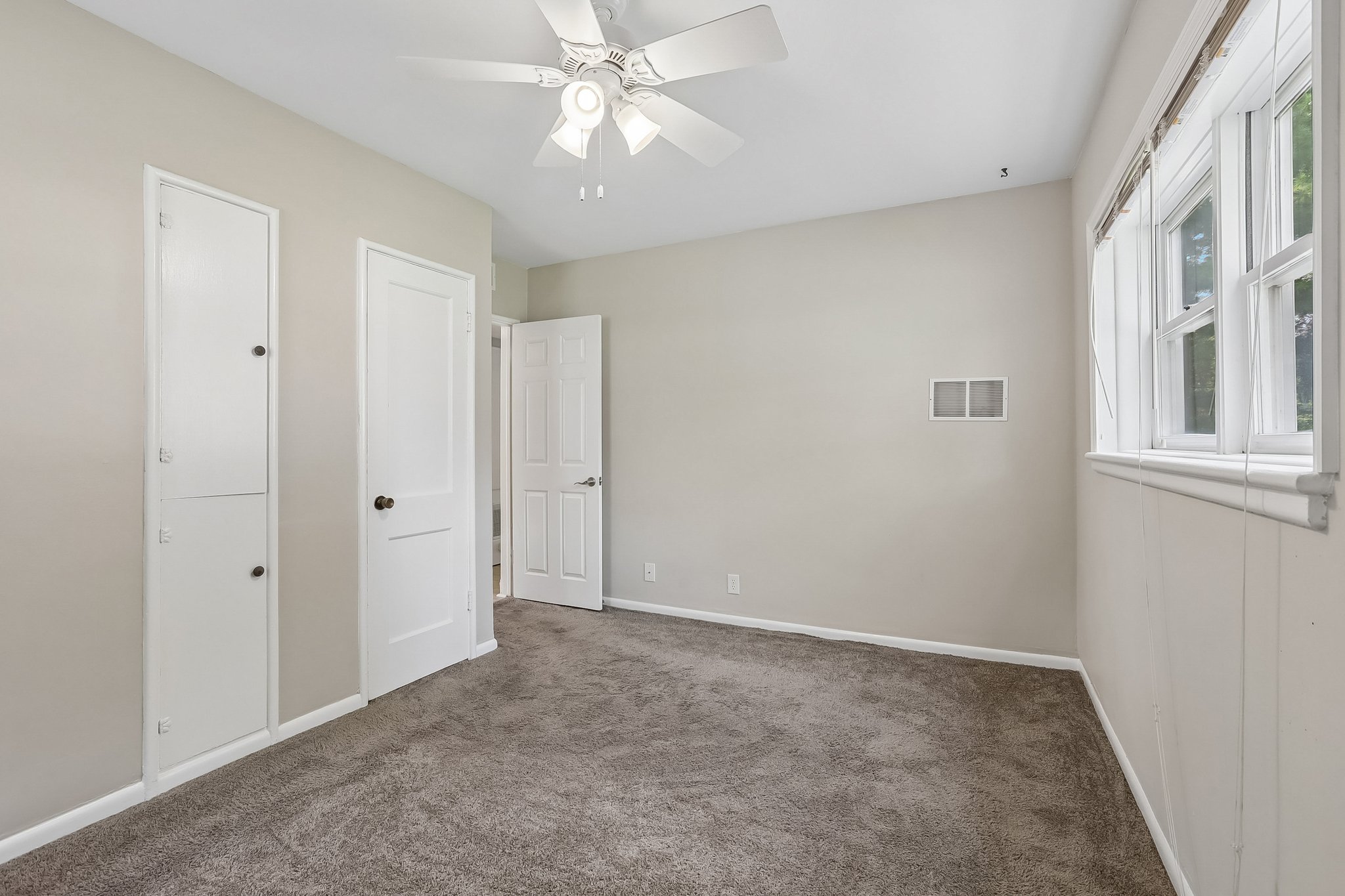 A second main-level bedroom provides another peaceful retreat with multiple windows and two closets.