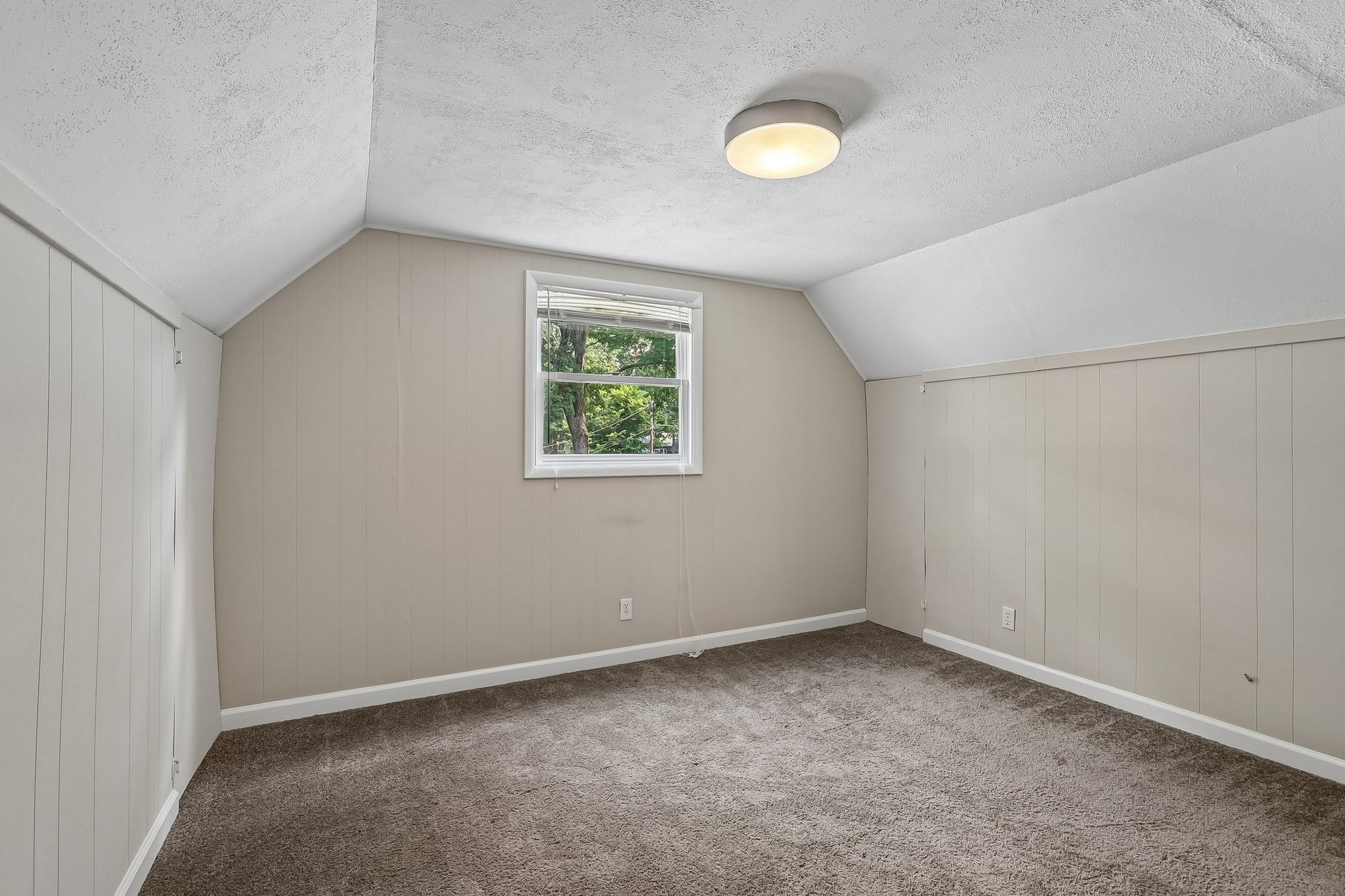 The second upper-level 3rd bedroom offers flexible space for overnight guests, a private office, or a creative studio.