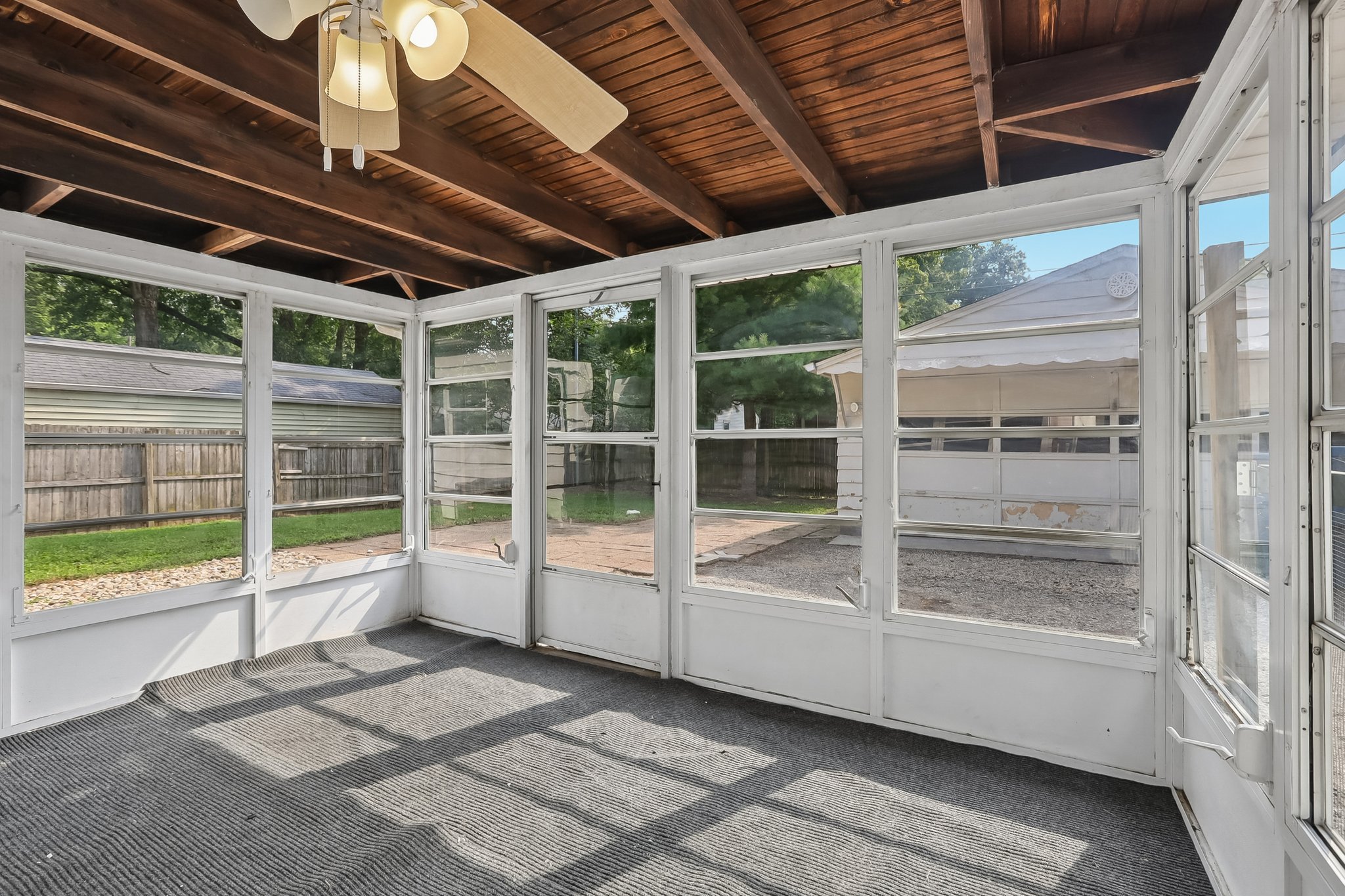 C The enclosed porch extends the living space toward the backyard, creating an easy connection between indoors and out.