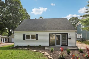 Picture-perfect Cape Cod curb appeal welcomes you home beneath a canopy of mature trees.