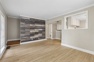 The open layout keeps the living room connected to the kitchen and dining area, making everyday life and entertaining feel effortless.