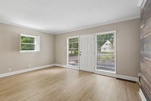Multiple windows brighten the spacious living area, creating an airy and welcoming place to feel at home.