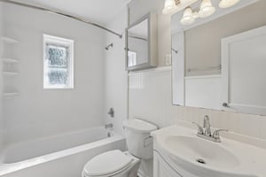 Start or end the day in a bright main-level bathroom with clean, neutral finishes and a tub-and-shower combination.