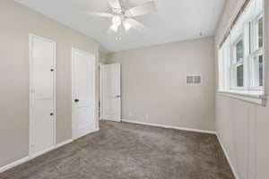 A second main-level bedroom provides another peaceful retreat with multiple windows and two closets.