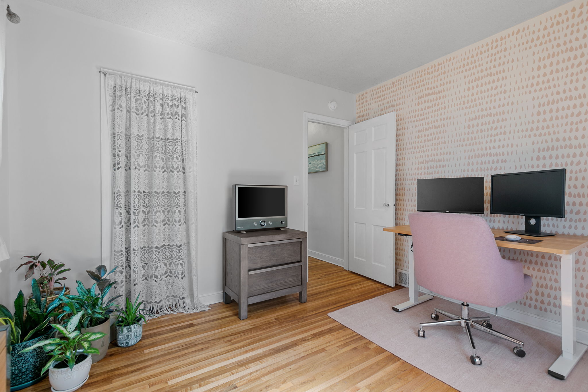 Pictured here, one of two main-level bedrooms at 5549 27th Avenue S is currently used as a home office.