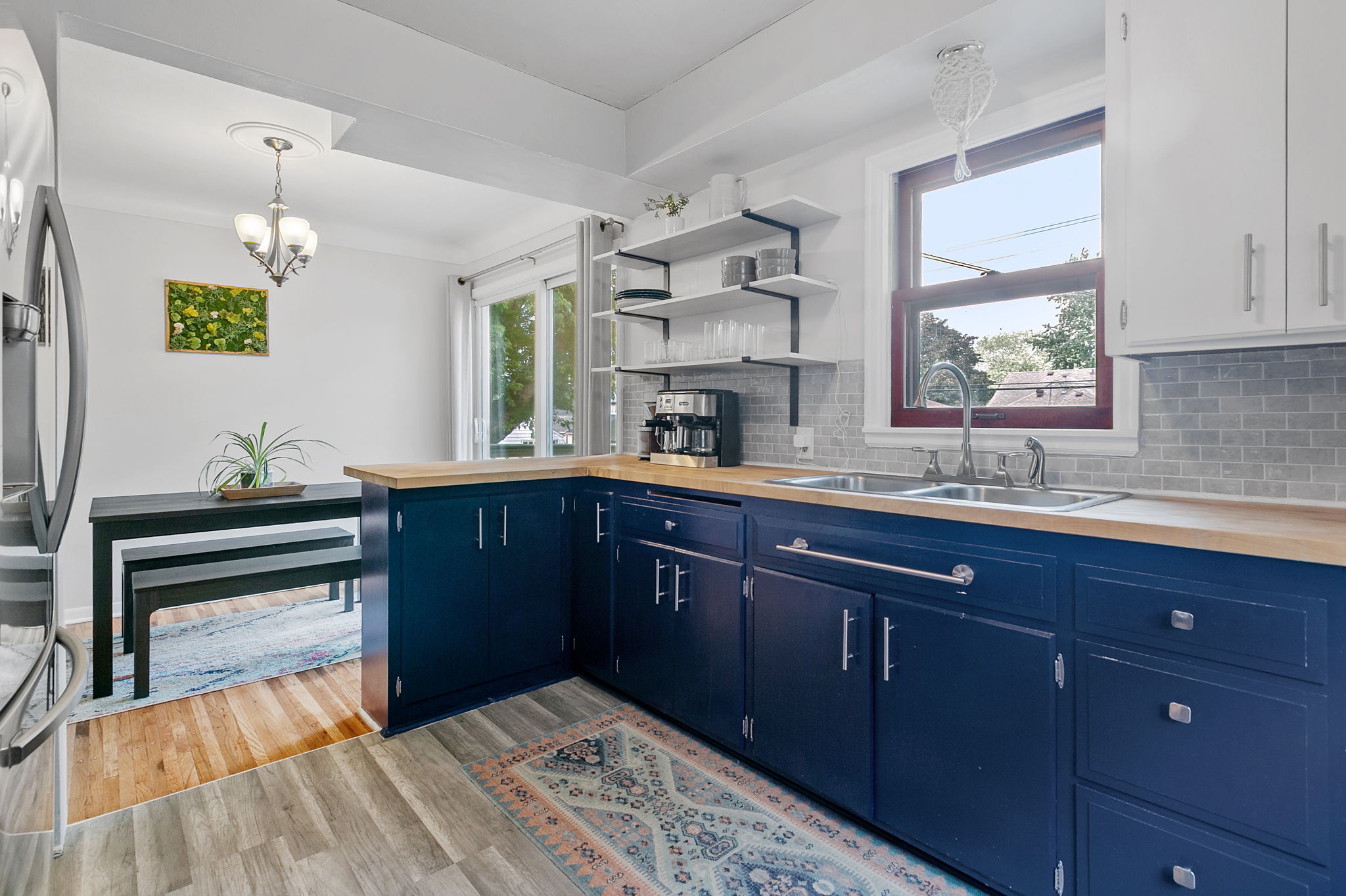 The kitchen at 5549 27th Avenue S is open to the informal dining space, providing a sense of spaciousness with views out to the privacy-fenced backyard.