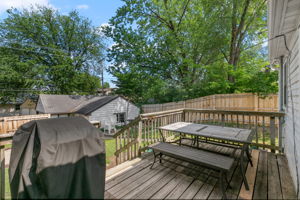A large wooden rear deck, circular paver patio, and full-coverage wooden steel-post privacy fence mean you're equipped for entertaining, gardening, and pets at 5549 27th Avenue S.