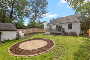 A large wooden rear deck, circular paver patio, and full-coverage wooden steel-post privacy fence mean you're equipped for entertaining, gardening, and pets at 5549 27th Avenue S.