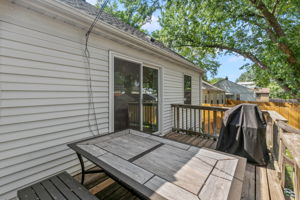 A large wooden rear deck, circular paver patio, and full-coverage wooden steel-post privacy fence mean you're equipped for entertaining, gardening, and pets at 5549 27th Avenue S.