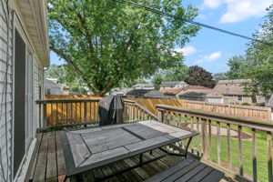 A large wooden rear deck, circular paver patio, and full-coverage wooden steel-post privacy fence mean you're equipped for entertaining, gardening, and pets at 5549 27th Avenue S.