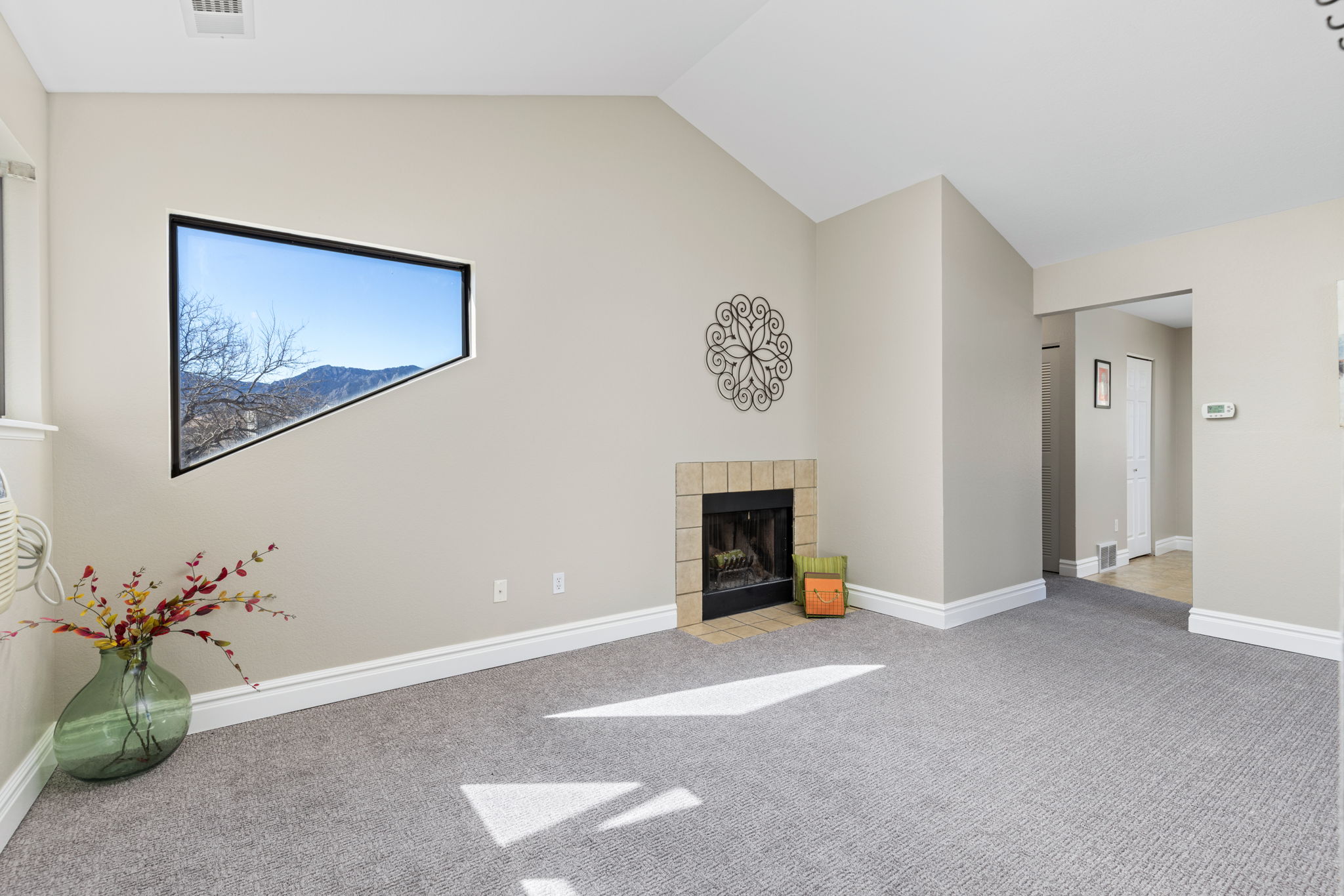 The Living Room features vaulted ceilings and a cozy fireplace