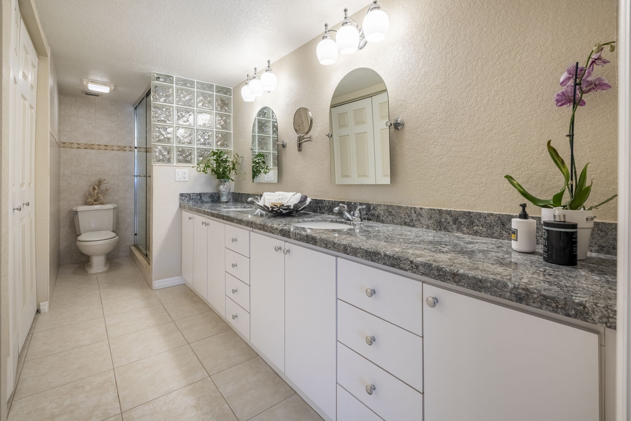 Ensuite master bath with tile floors, marble counters