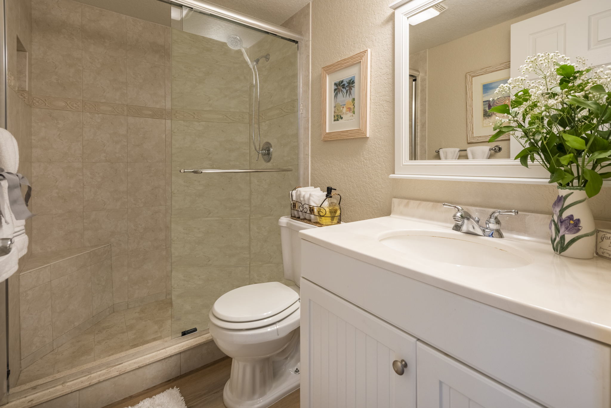 Updated guest bath with granite counter, and floor-to-ceiling tiled shower