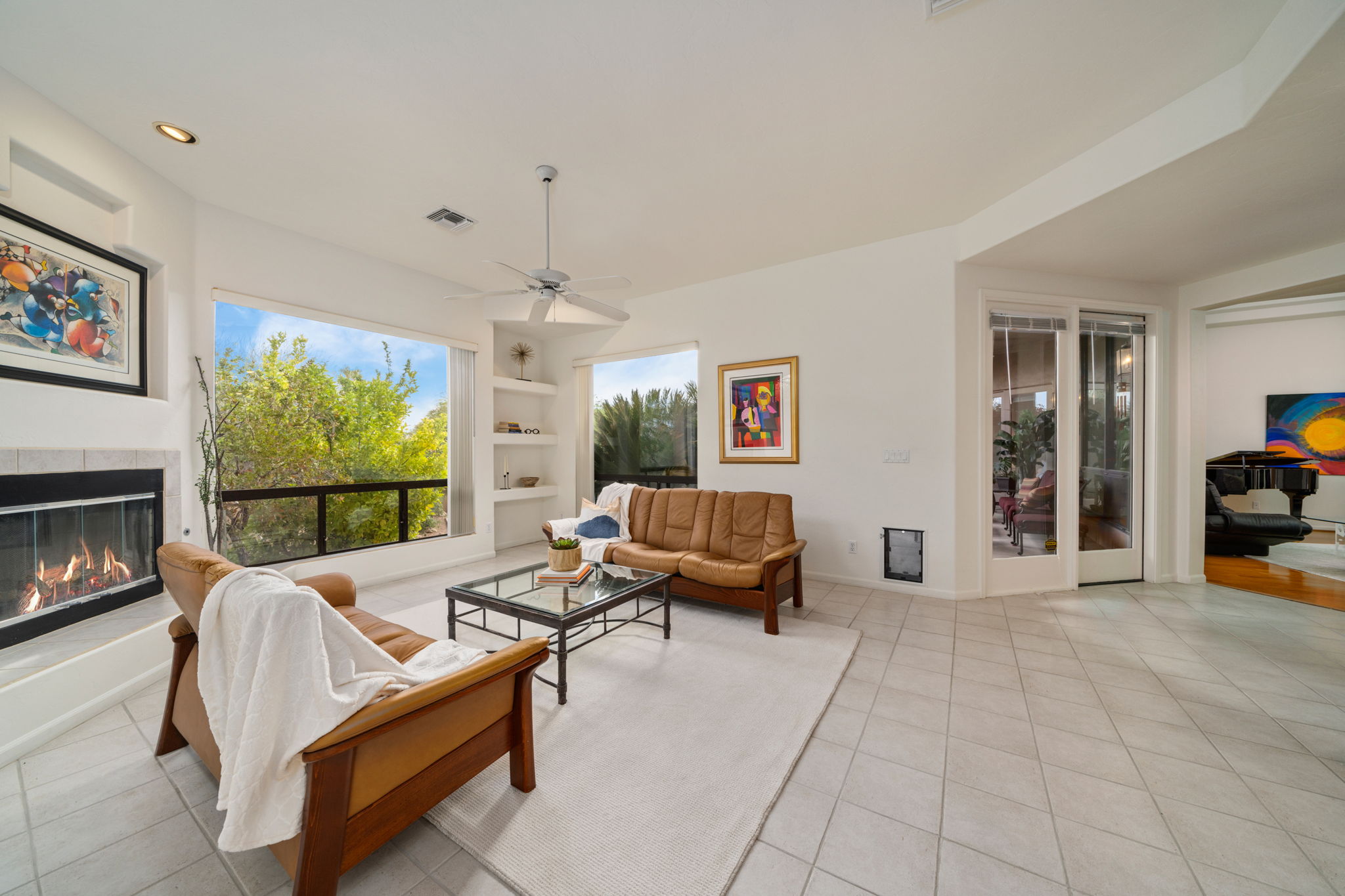 Family Room with wood burning fireplace, bookshelves and large windows