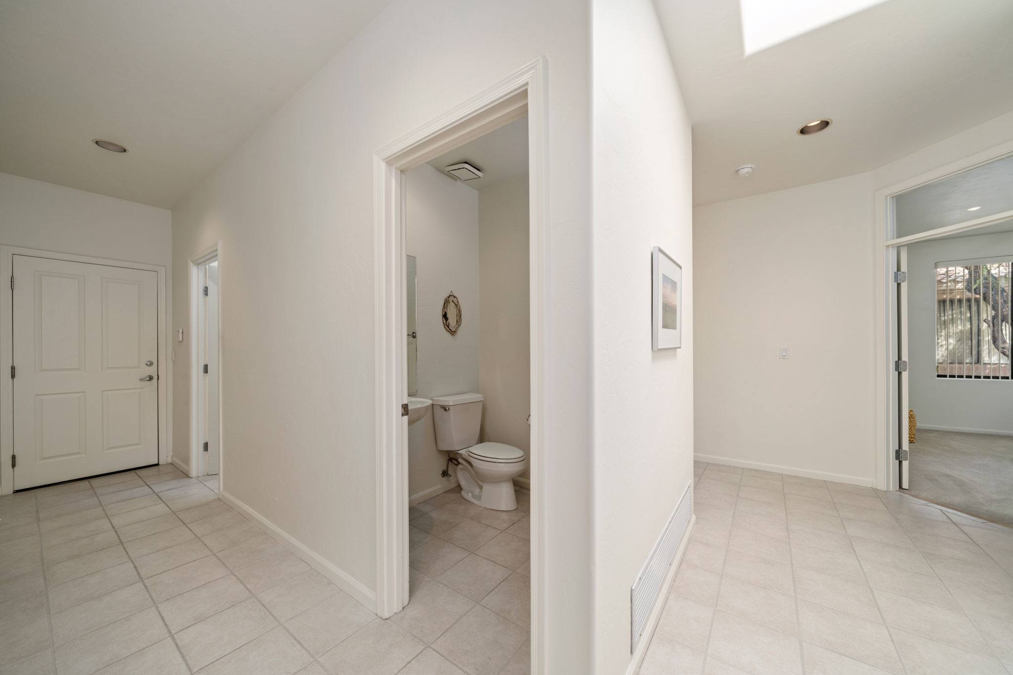 Hallway view to Powder Room, Laundry Room and Garage