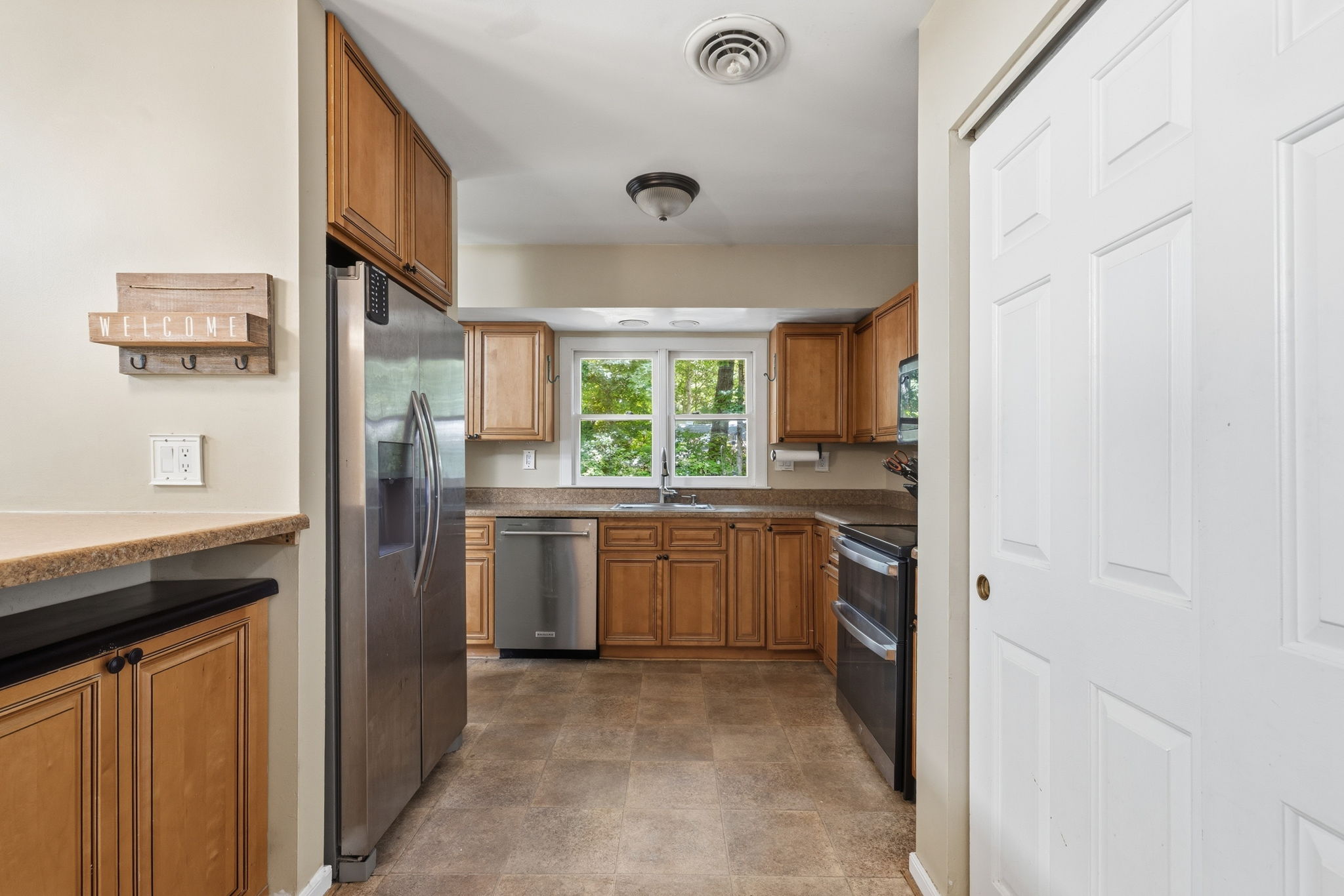 Large laundry closet adjacent to kitchen with washer and dryer.