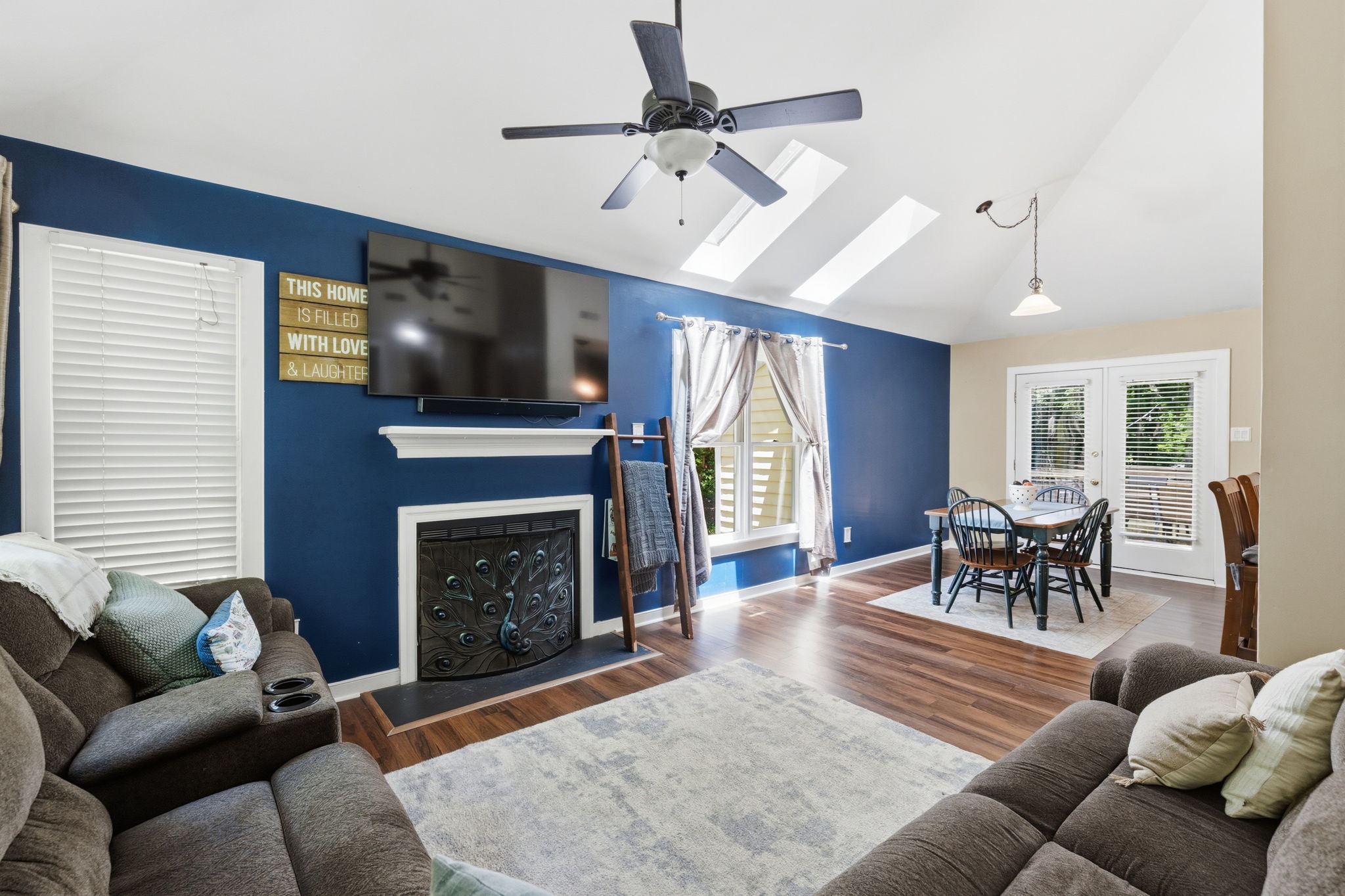 Open living room with vaulted ceilings and a ceiling fan.
