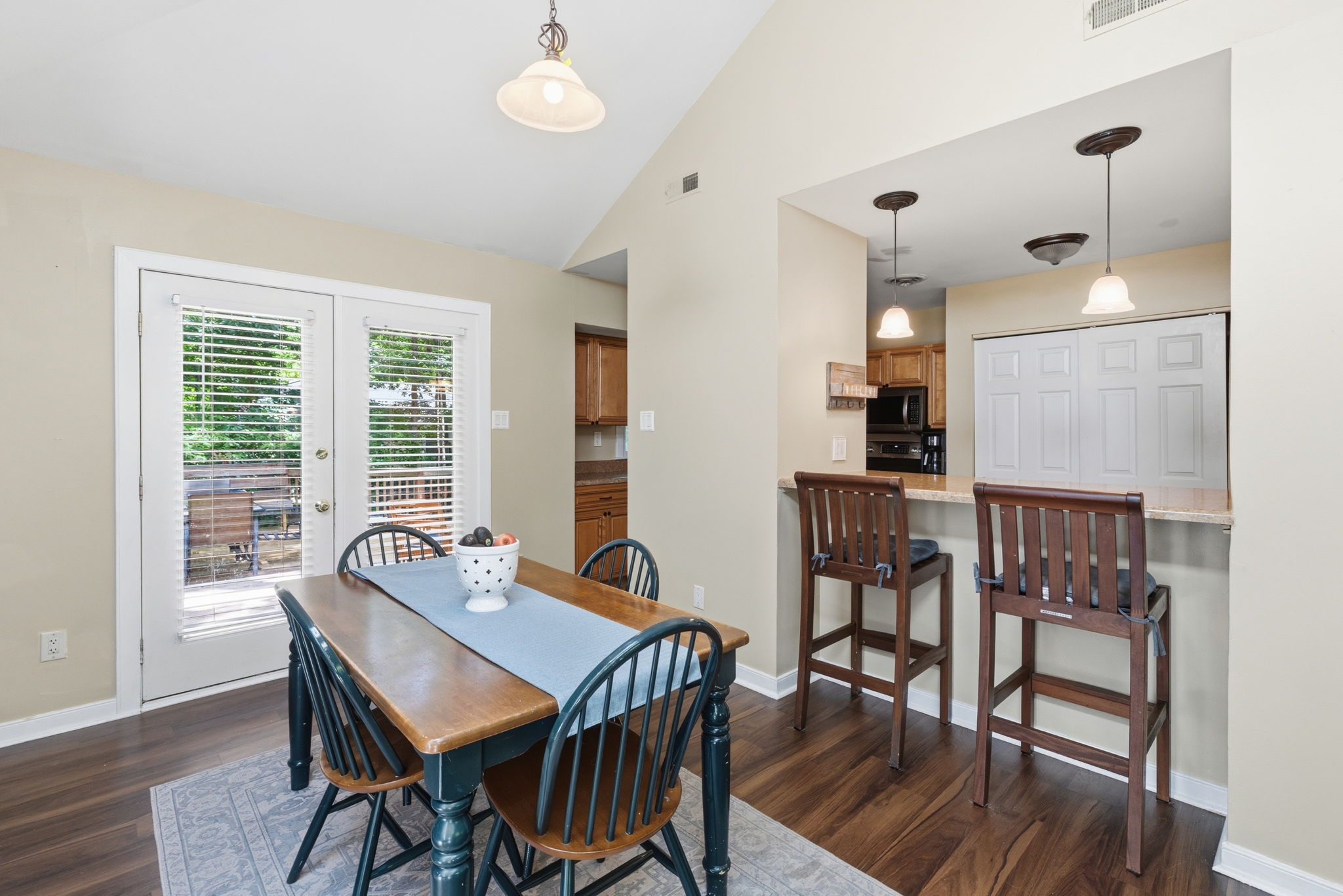 Dining area is adjacent to the kitchen and opening at breakfast bar allows for full view of dining area and living room.