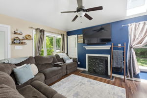 The living room has a wood burning fireplace.