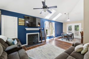 Open living room with vaulted ceilings and a ceiling fan.