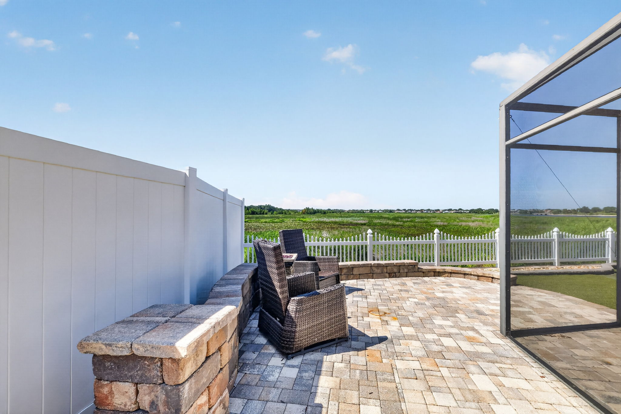 Extended Rear and Side Paver Patio with Privacy Fencing and Tiered Wall