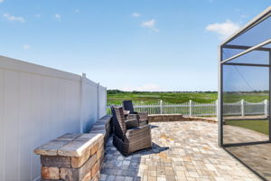 Extended Rear and Side Paver Patio with Privacy Fencing and Tiered Wall