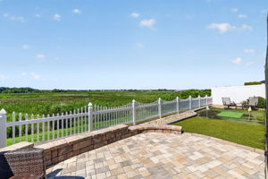 Extended Rear Paver Patio with Privacy Fencing, Tiered Wall ,and Putting Green