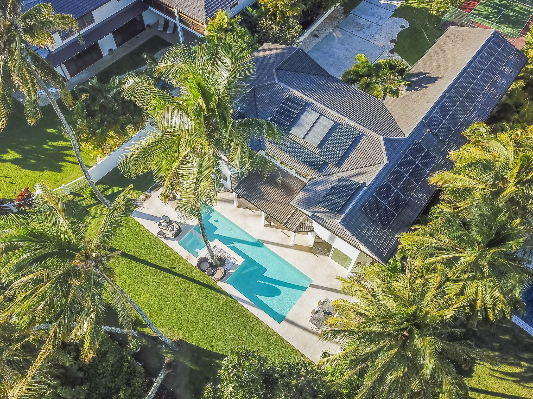 Aerial view of this lovely oceanfront home with XL pool & backyard