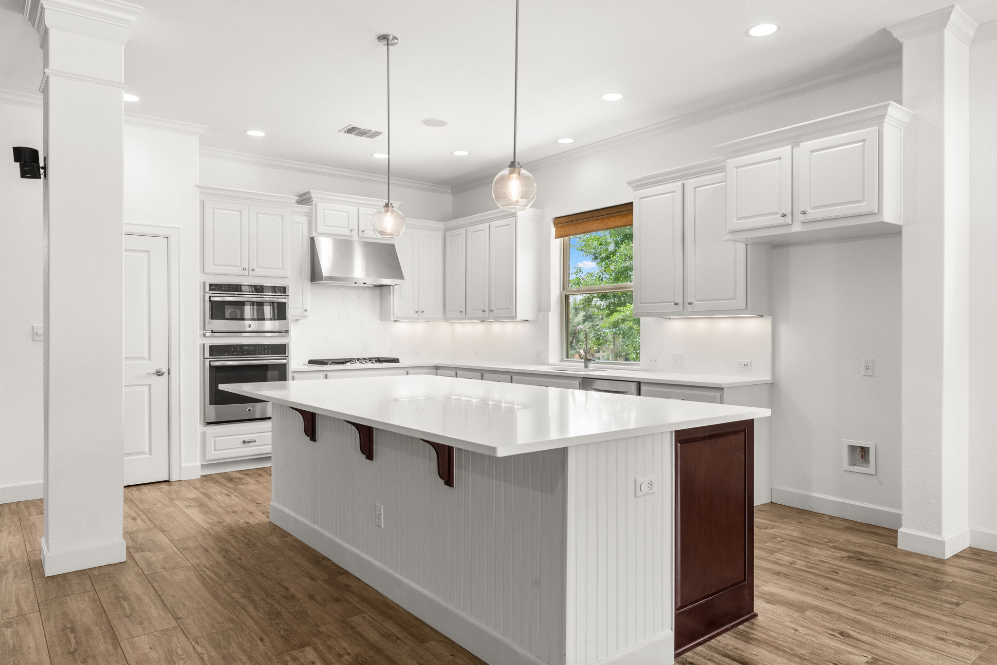 The kitchen is huge and has been updated with new quartz counters, backsplash, paint, and lighting.