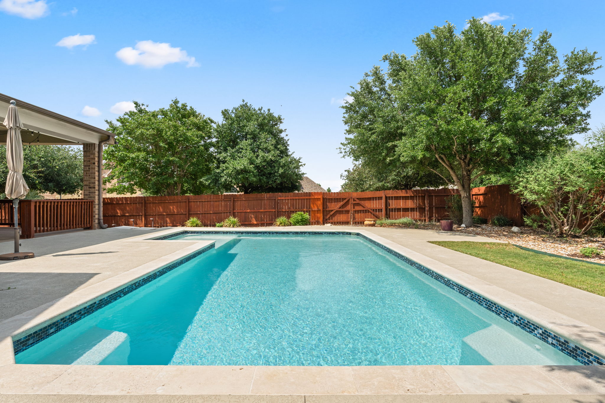 The backyard features a gorgeous pool.