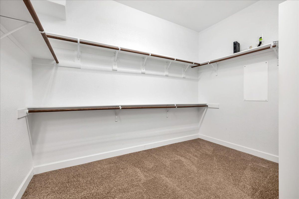 Just one section of the massive primary walk-in closet!