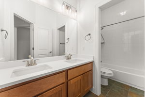 Full guest bath with double vanity is located downstairs. Features new quartz counters, lighting, and fresh paint.
