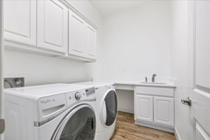 The laundry room has fresh paint, new quartz counters, and a new sink.