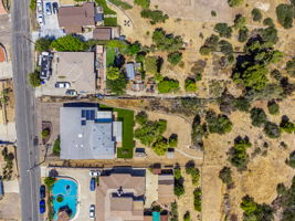Overhead view of home on .82 acre property goes past fence line
