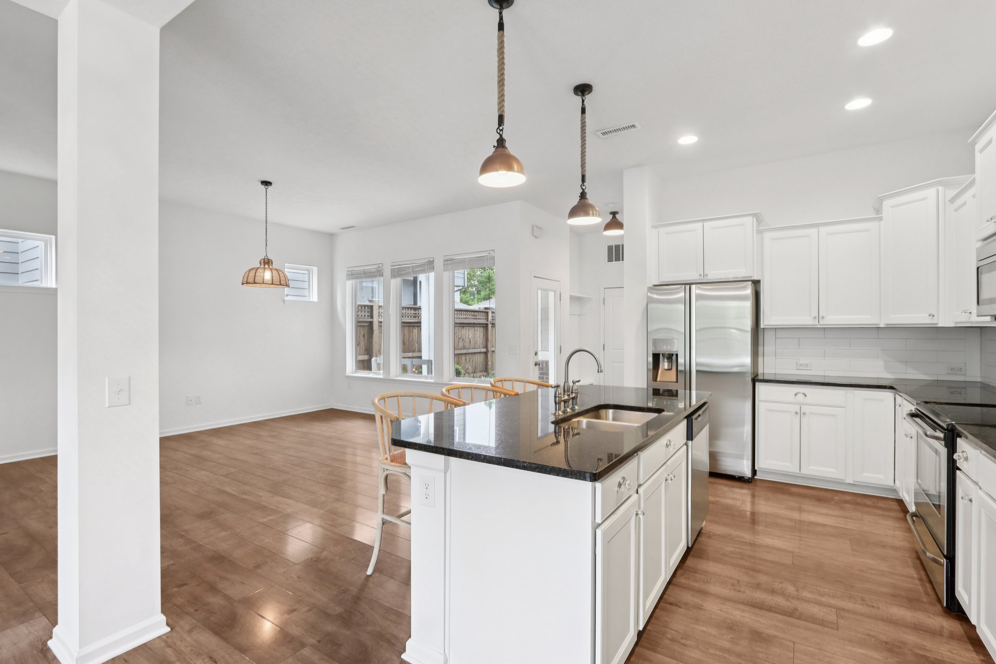Custom lighting, clean lines, and built-ins set the stage for flexible, functional living.