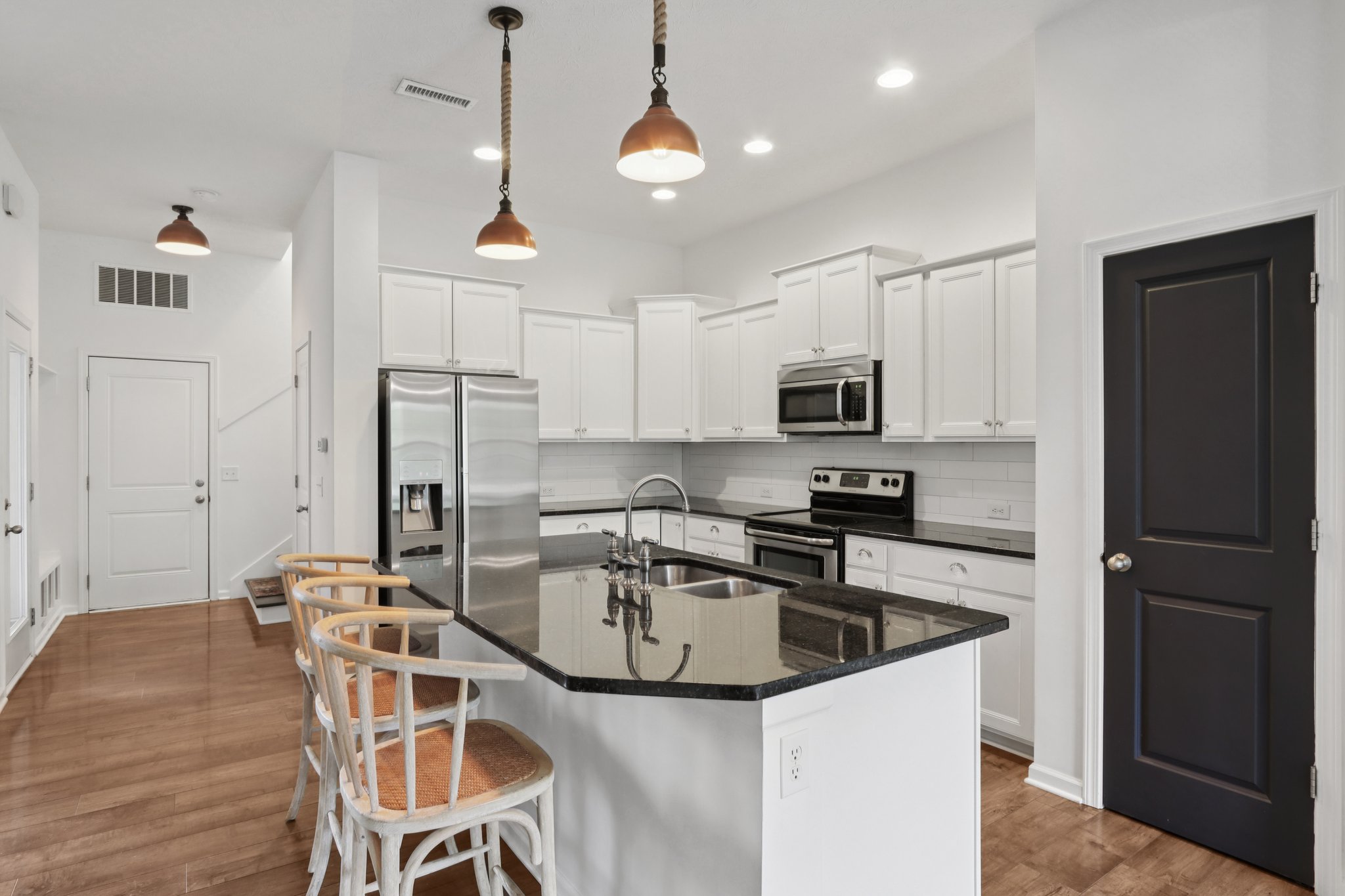 Spacious and stylish kitchen with oversized island, ample prep space, and bar seating for gatherings.