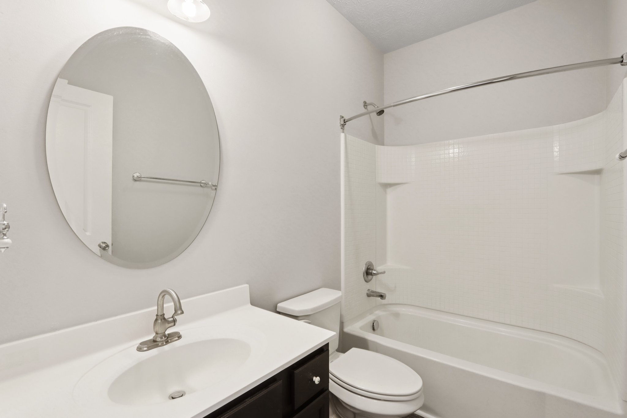 Fresh and functional guest bath with a clean modern vanity and shower/tub combo.