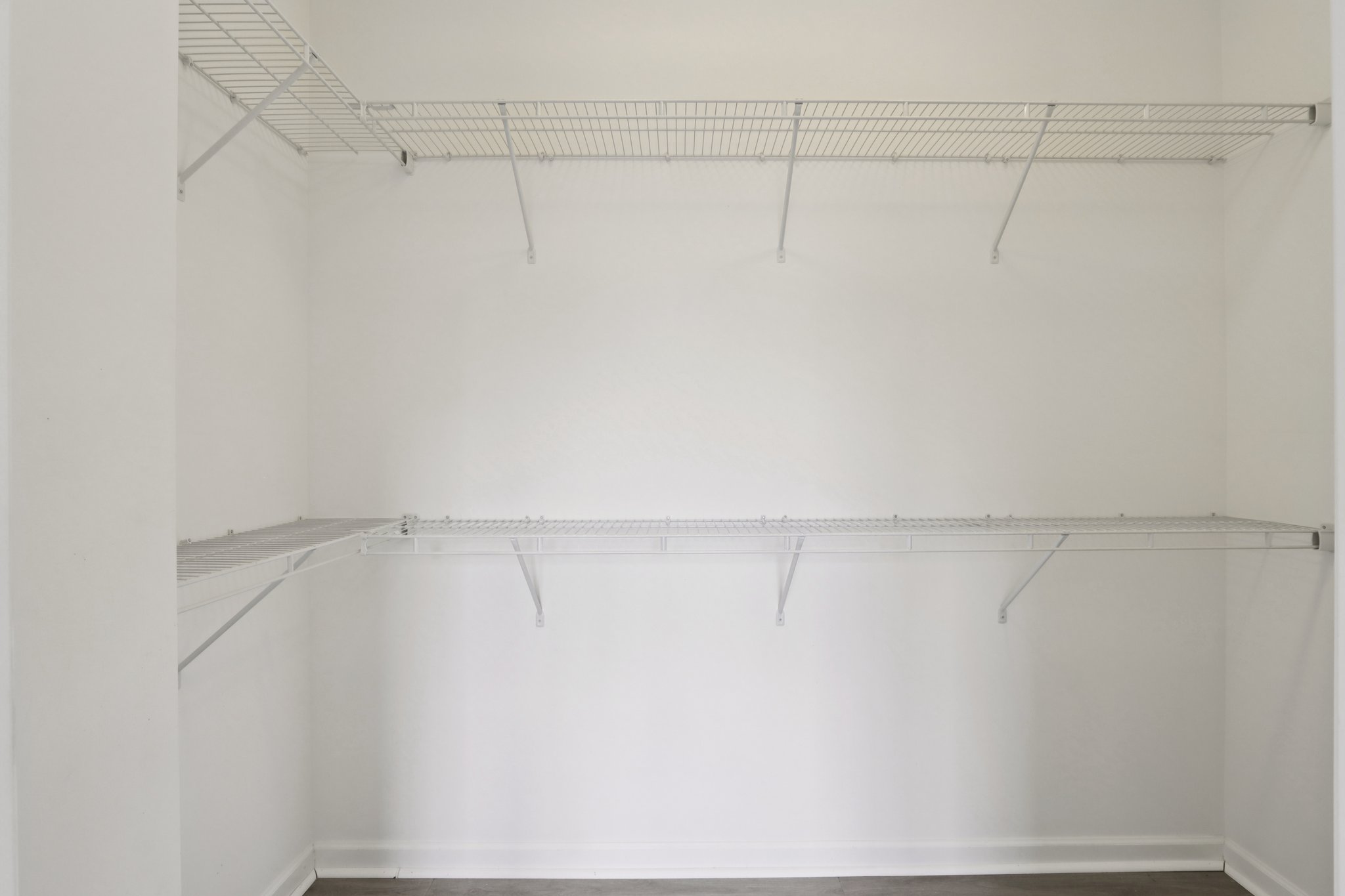 Expansive walk-in closet in the primary suite with built-in shelving and generous hanging space.